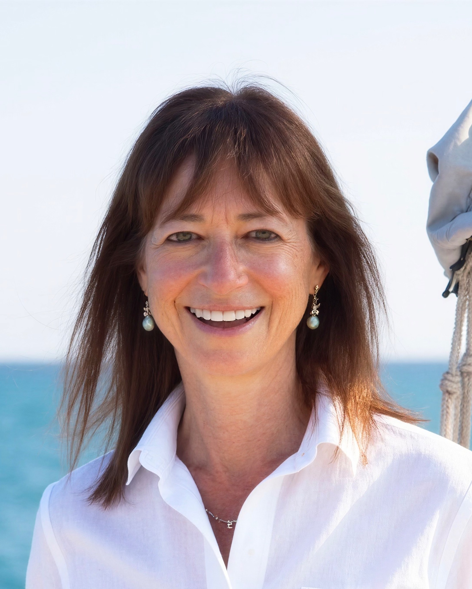 Nedra Fetterman smiling beside the sea